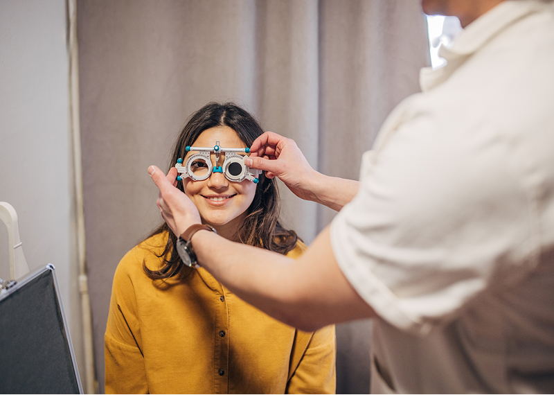 Optometrist adjusting trial frames