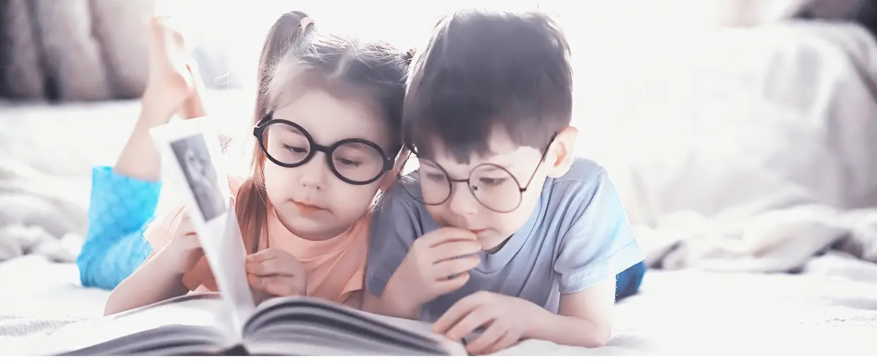 Children reading a book together